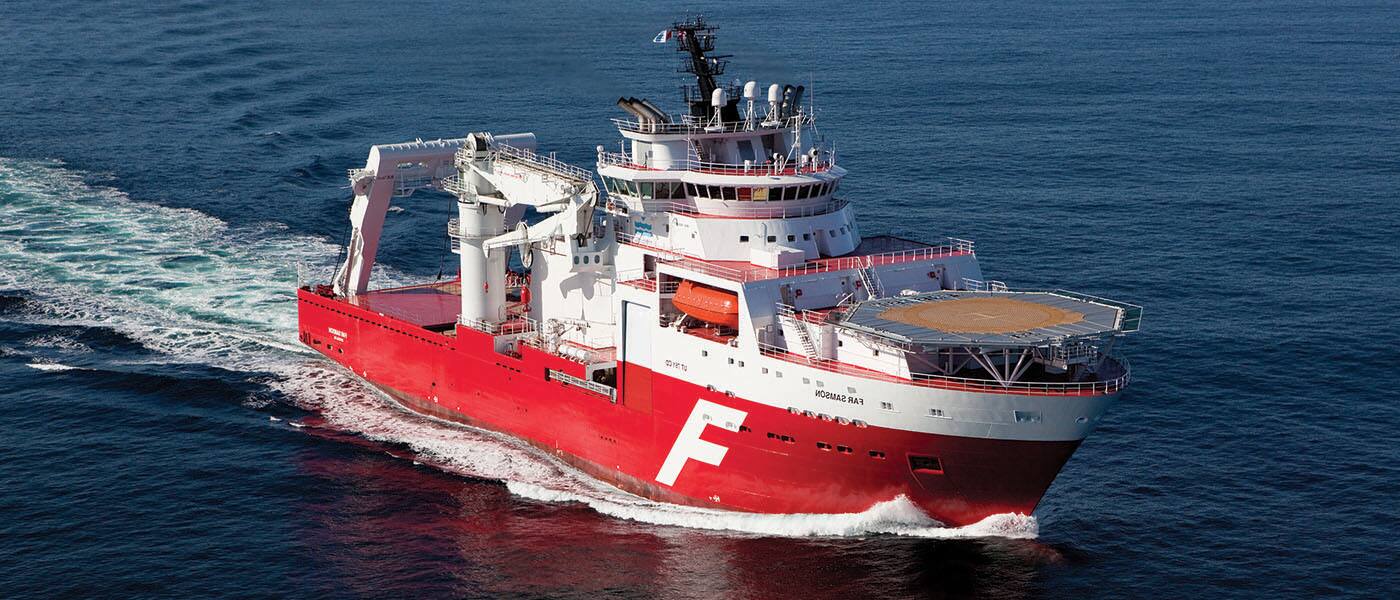 An industrial ship with a helipad in the ocean