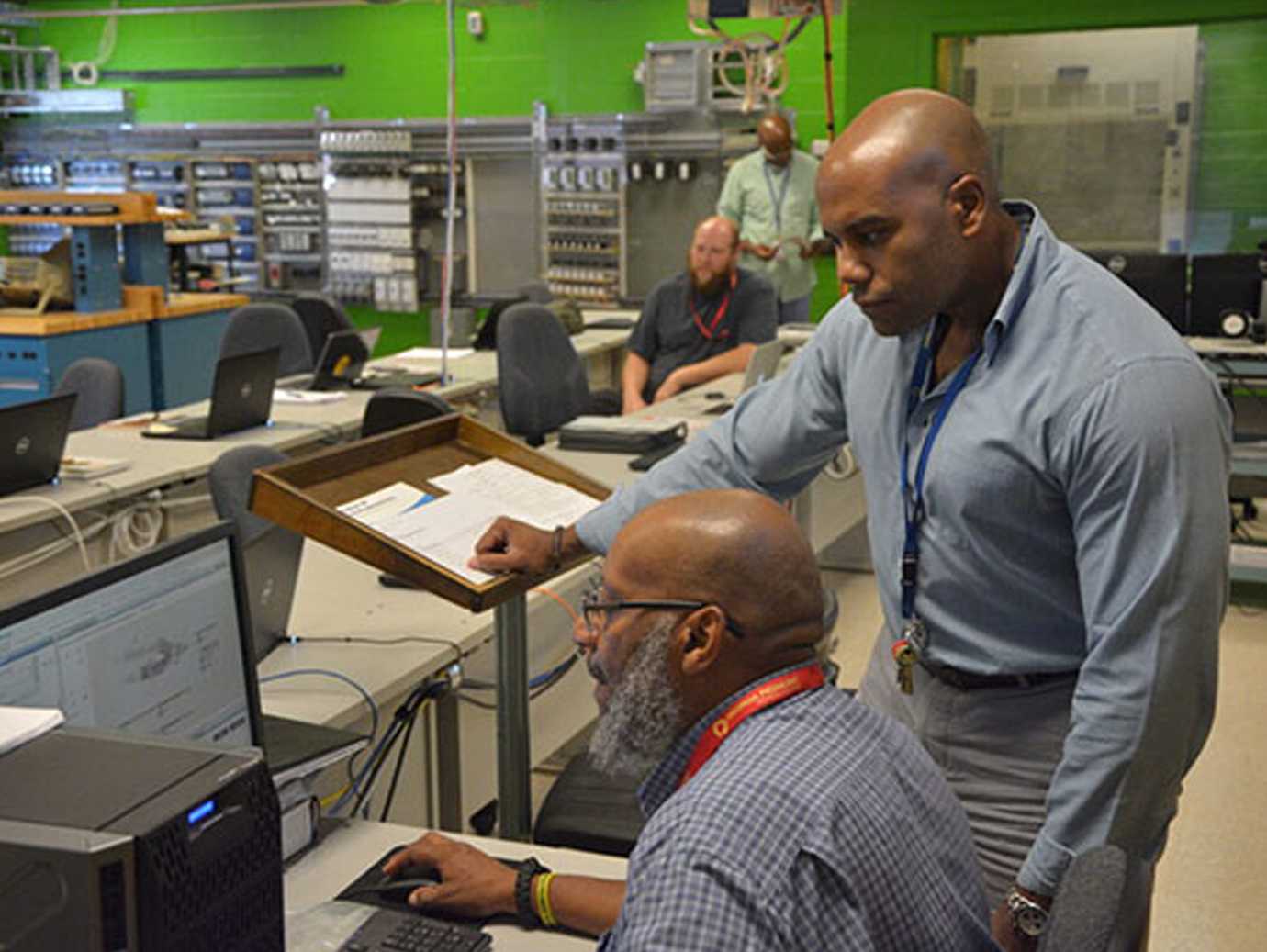 Two men looking at laptop