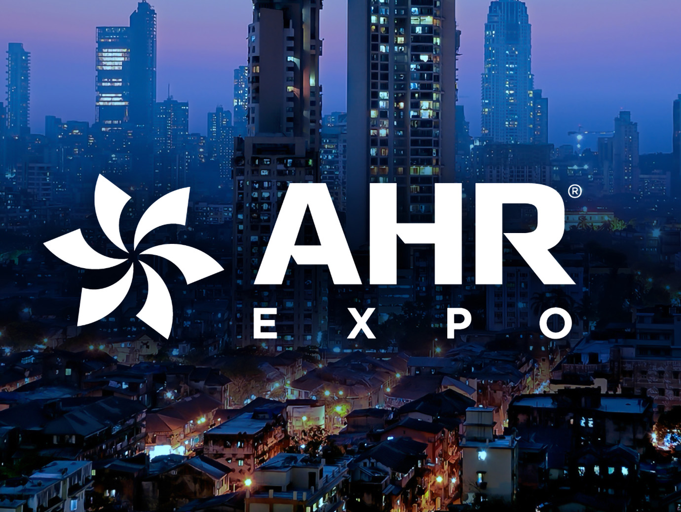 Night view of modern buildings with AHR Expo text written 