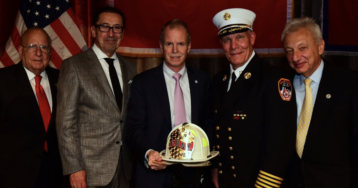 George Oliver, CEO of Johnson Controls, standing with top personnel of the Fire Department of New York after receiving their Humanitarian Award