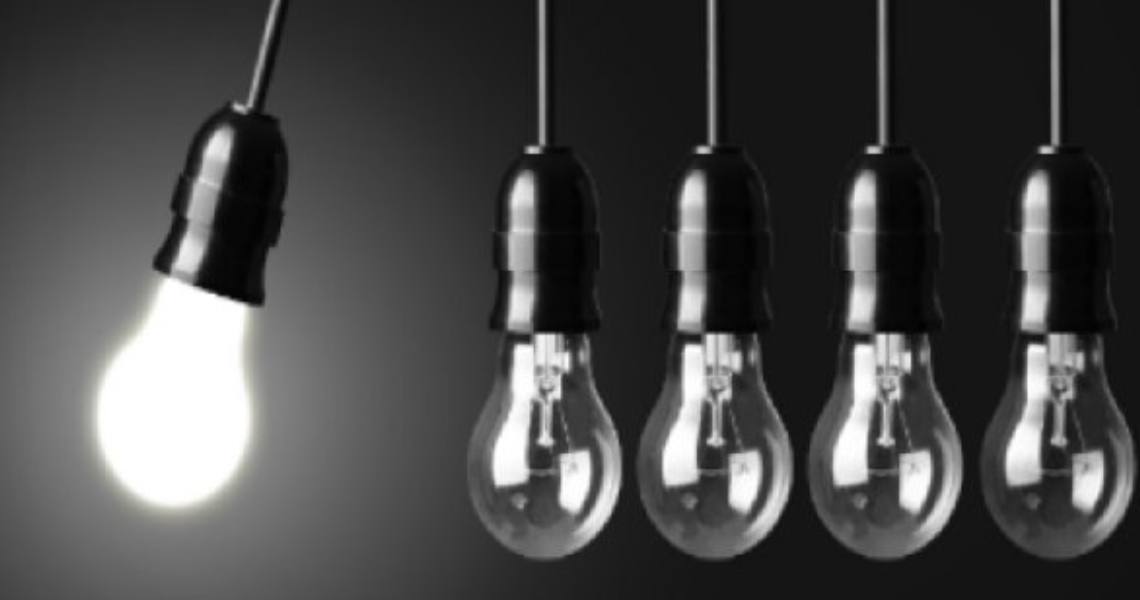 Five lightbulbs hanging in a row, with one lit up and swinging