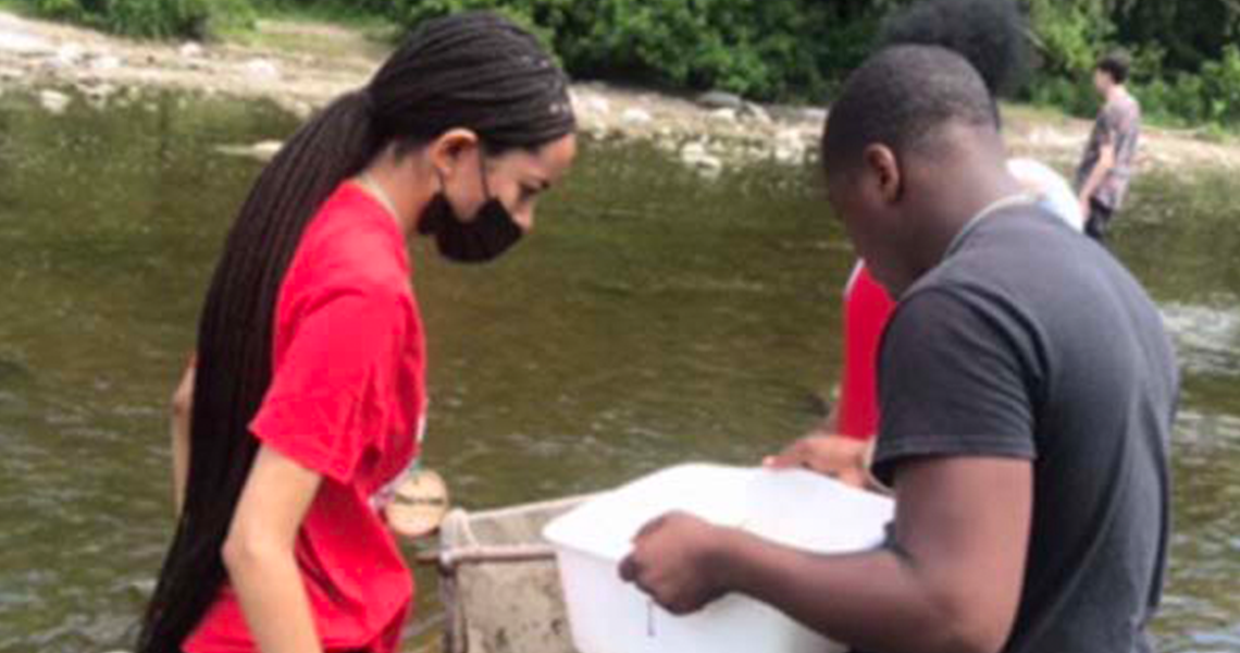 A man and women searching something in the river