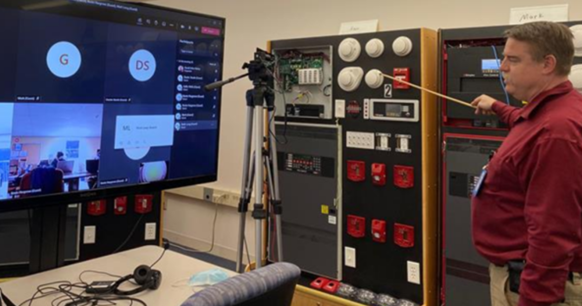 An instructor teaching a virtual class as employees work from home
