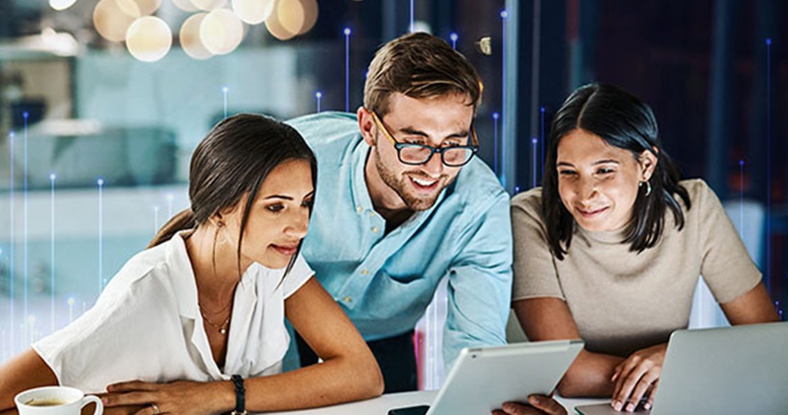 Corporate employees in an office, looking at a screen tablet and smiling