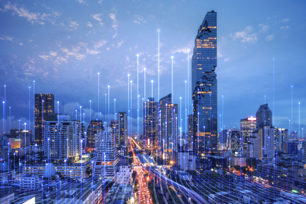 Cityscape during night-time, overlaid with a graphic depicting transmission nodes