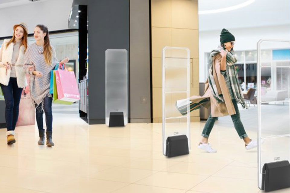 Women walking through the EAS security sensor in a shopping mall