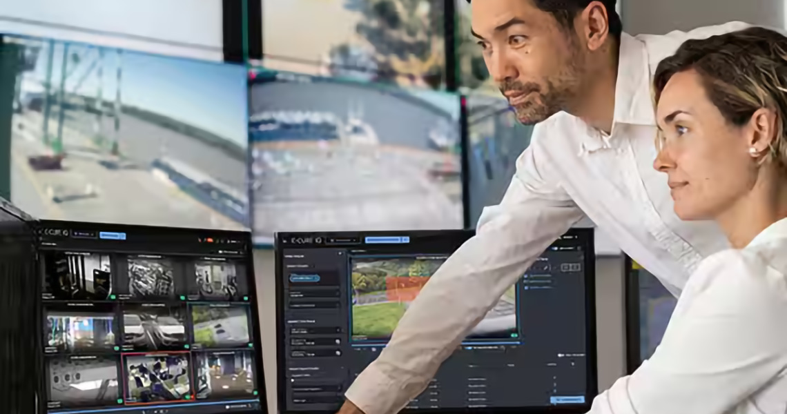 Two employees working on computers with "Software House" written at the bottom right side