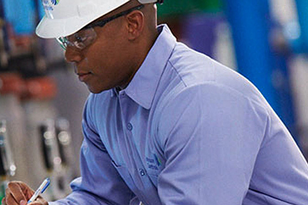 Man in Johnson Controls safety equipment taking down machine readings